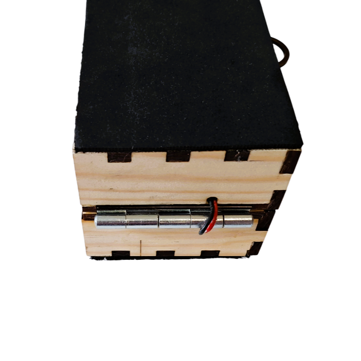 Close up of the rhythmic hinge, showing both drum boxes neatly folded to lay on top of one another via a metal hinge.