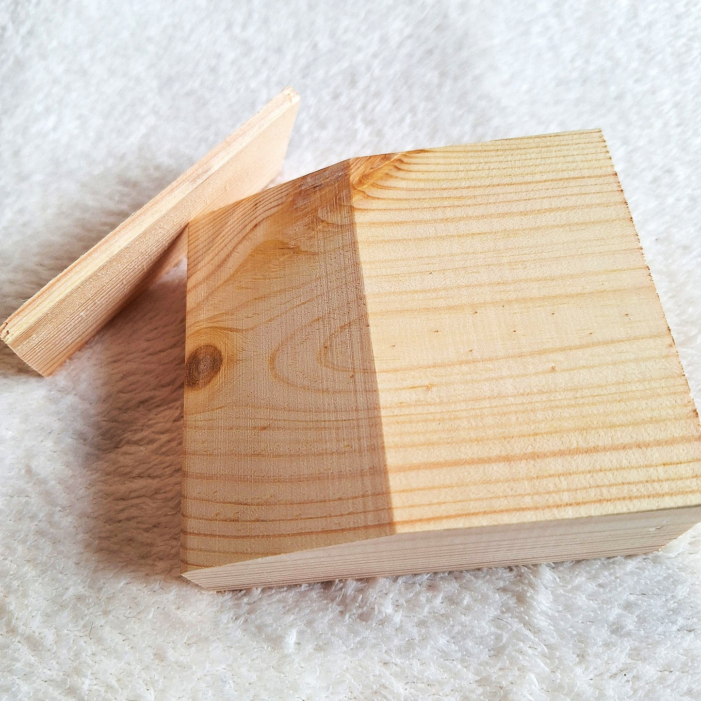 Top side view of a solid oak stomp box enclosure cut to a wedge shape and showing a matching endplate, ready to to be used in a home built build. On a white background.
