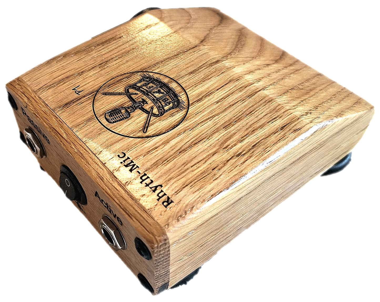 Rhyth-mic P1 play-through stompbox in solid oak wood showing laser etched branding of a microphone on a drum plus an on off switch, and passive and active input output 1/4 " jacks