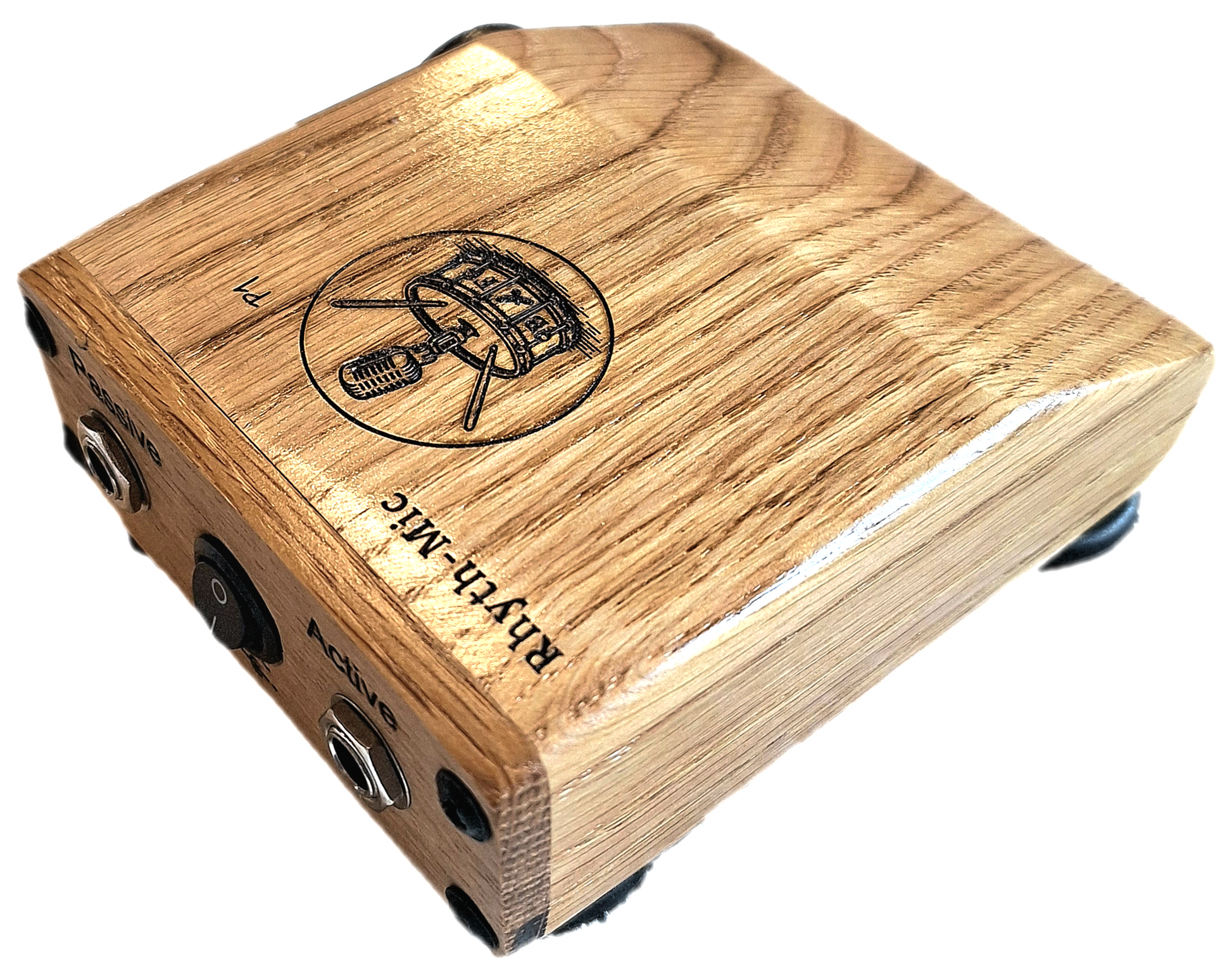 Rhyth-mic P1 play-through stompbox in solid oak wood showing laser etched branding of a microphone on a drum plus an on off switch, and passive and active input output 1/4 " jacks