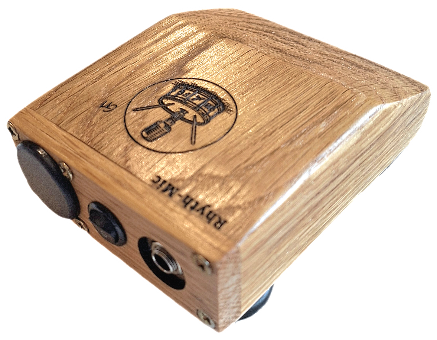 Another view of the Rhyth-Mic G1 posed rear oblique view showing off attractive oak construction, wedge shape and laser etched graphics and branding., on/off switch, battery cover and 6.3mm output jack