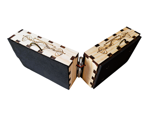 Opened front top oblique view of  'The Rhythmic' described as two laser-cut and etched pine boxes, both with a brass D-ring on the upper box edge, with one surface of each box covered in neoprene foam, hinged with a metal connector and connected discretely with 2 wires. On a transparent background.