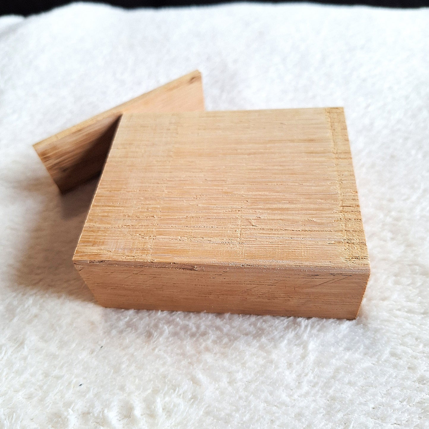 Side view of a solid oak stomp box enclosure and end plate ready to to be shaped and used in a home built project. On a white background.