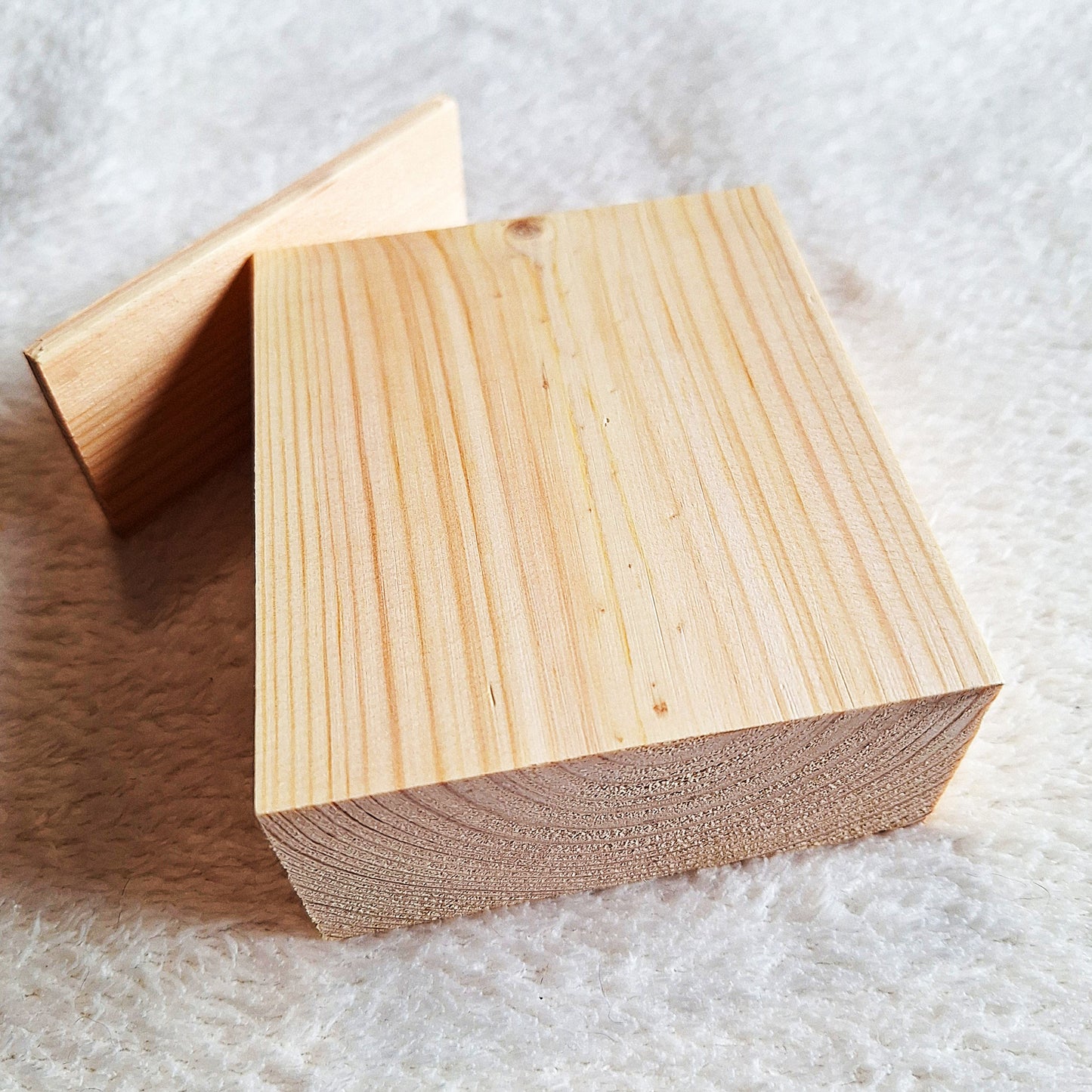 Top rear view of a solid pine stomp box enclosure and end plate ready to to be shaped and used in a home built project. On a white background.