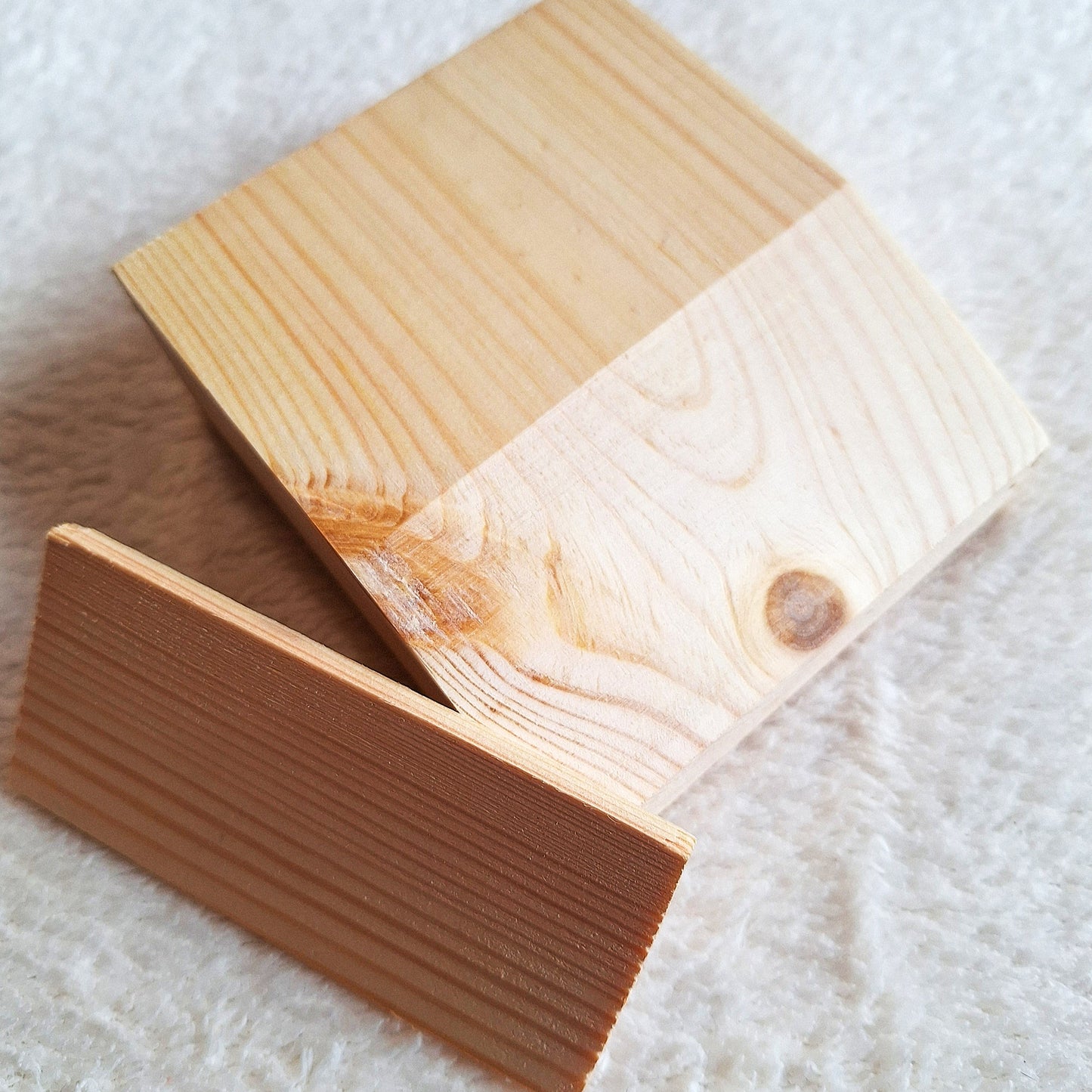 Top oblique view of a solid pine stomp box enclosure cut to a wedge shape and showing a matching endplate, ready to to be used in a DIY build. On a white background.
