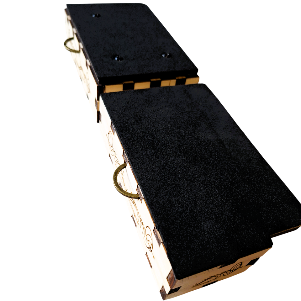 oblique top view of both of the rhythmic drum pads, showing neatly cut black neoprene foam covering both sides of this mini wearable cajon. On a white background