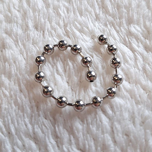 coiled 7cm length of linked metal beads on a white background