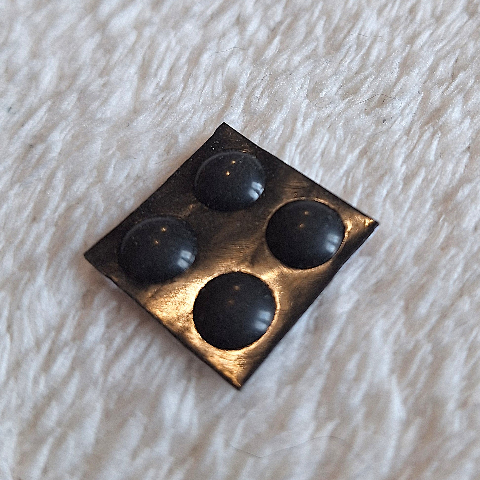 four 3mm rubber dot feet on a black self-adhesive backing White backround.