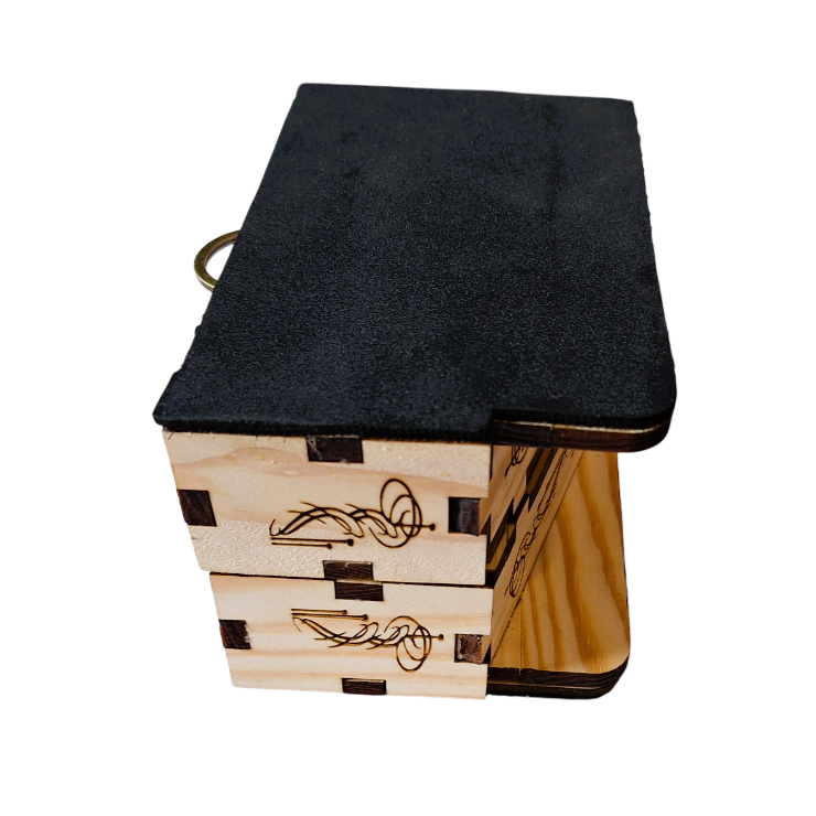 a top side view of The  rhythmic, showing how it can be folded for transport. Both boxes laying face-outwards and stacked upon each other, connected by a metal hinge.